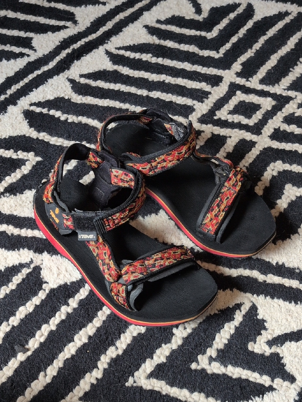 Women's Teva Black Sandals with Red and Orange Patterned Straps